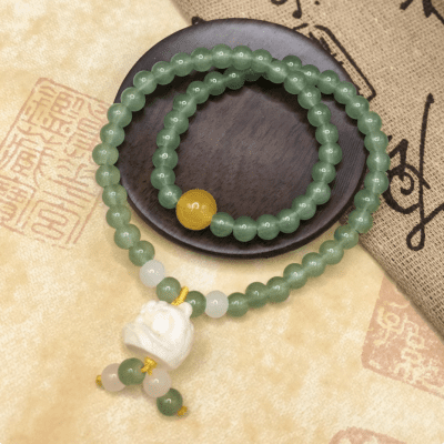 A jade charm bracelet featuring a Pi Xiu, believed to attract wealth and fortune.